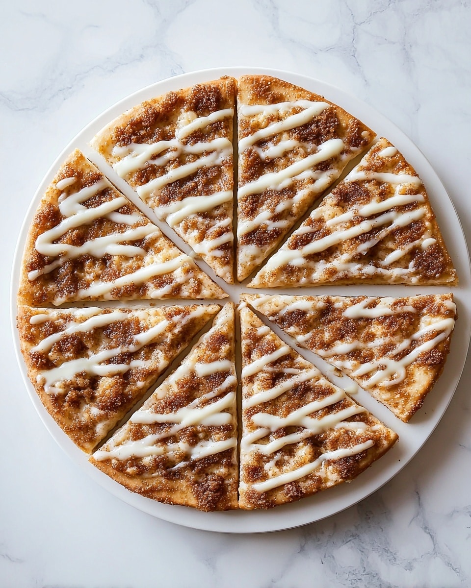A round dessert pizza cut into eight equal slices sits on a white plate on a white marbled surface. The crust is golden brown and slightly thick. The base layer is light-colored, looking like melted cheese or cream. Above this is a layer of crumbly brown sugar and cinnamon streusel spread evenly, giving a rough texture. The top layer features thick white icing drizzled across the pizza in diagonal lines. The edges of the crust have a dusting of powdered sugar that adds a soft white touch. photo taken with an iphone --ar 4:5 --v 7