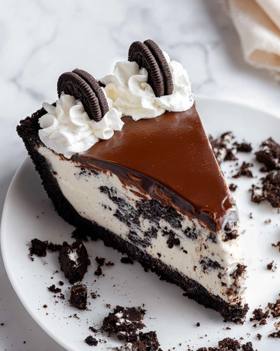 A slice of cookies and cream pie is on a white plate with a white marbled background. The pie has three layers: a thick, dark brown crumbly cookie crust on the bottom and sides; a white creamy filling with visible chunks of dark cookies mixed in the middle; and a smooth, glossy dark chocolate ganache layer on top. The slice is decorated with white whipped cream dollops near the crust edge, each topped with a small cookie. Around the plate, broken cookie pieces are scattered, adding texture to the scene. Photo taken with an iphone --ar 4:5 --v 7