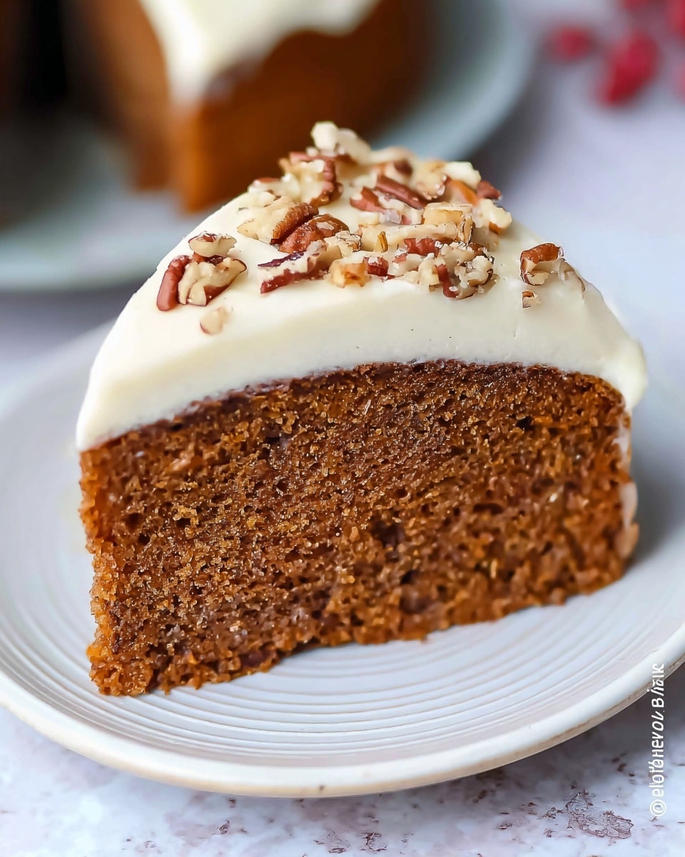A single slice of dark brown cake with a soft, moist texture sits on a white plate with a subtle swirl pattern, placed on a white marbled surface. The cake has one layer topped with a thick, creamy white frosting, and scattered on top are pieces of pecans, adding a rough, crunchy detail. The background is softly blurred, highlighting the cake slice as the main focus. Photo taken with an iphone --ar 4:5 --v 7