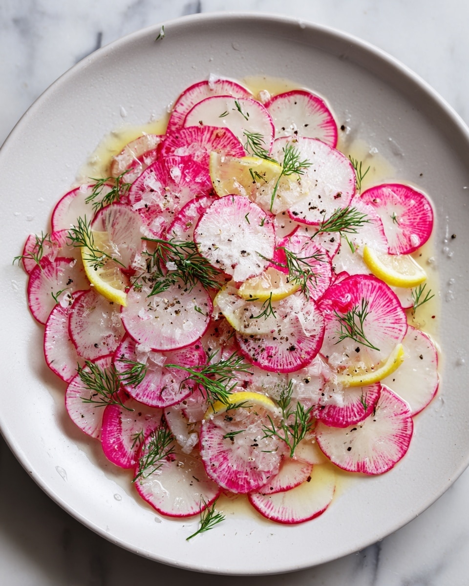 A close-up view of a dish with thinly sliced radishes forming a single, loose layer on a white speckled plate with a brown rim. The radishes are pale white in the center with bright pink edges. Scattered on top are small lemon wedges, green sprigs of fresh dill, coarse salt, and cracked black pepper, all sitting in a light dressing that creates a slightly shiny texture. The plate is placed on a white marbled surface. photo taken with an iphone --ar 4:5 --v 7
