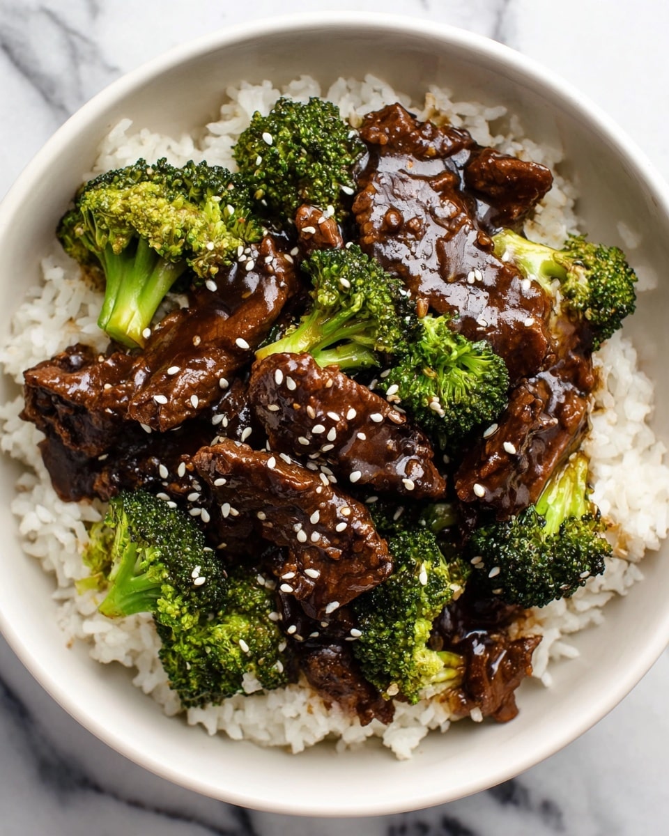 A bowl of white rice forms the base layer, topped with a glossy dark brown beef and broccoli stir-fry sauce that coats thin slices of beef and bright green broccoli florets scattered evenly. White sesame seeds are sprinkled over the top, adding a contrasting texture and color. The dish sits in a white bowl, placed on a white marbled surface. photo taken with an iphone --ar 4:5 --v 7