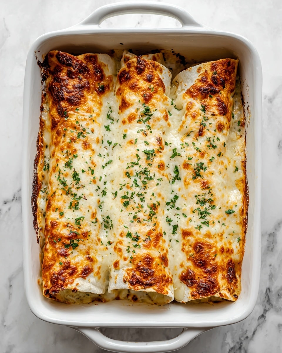 The image shows a white rectangular baking dish filled with three large rolled tortillas covered in melted golden cheese. The cheese on top is bubbly and browned in spots, with melted strands stretching from one roll being pulled up. The rolls have a slightly browned, soft texture and are sprinkled with chopped green herbs on the cheese layer. The dish sits on a white marbled surface. photo taken with an iphone --ar 4:5 --v 7