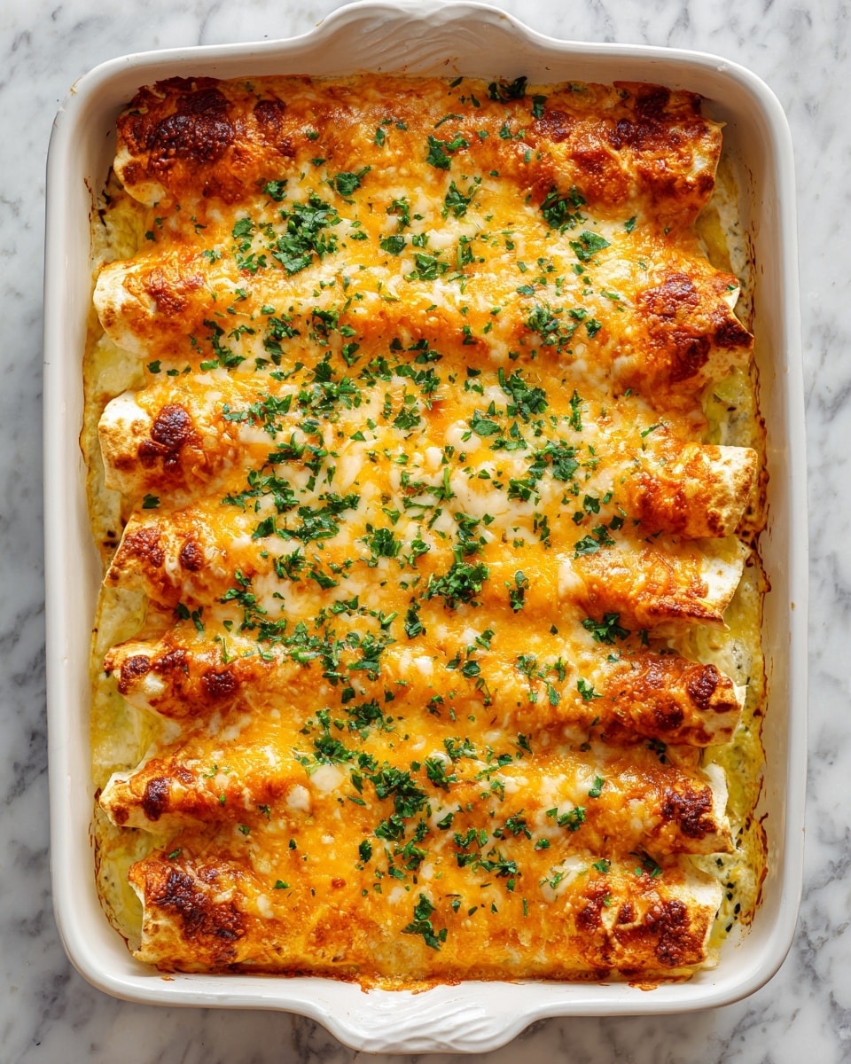 The image shows a white baking dish filled with eight rolled enchiladas arranged in two rows of four. Each enchilada is covered with melted golden yellow cheese that looks slightly bubbly and toasted on top. Bright green chopped herbs are sprinkled evenly across the cheesy surface, adding a fresh contrast. The edges of the enchiladas peek out slightly beneath the cheese, showing soft, lightly browned tortillas. The dish sits on a white marbled surface. photo taken with an iphone --ar 4:5 --v 7