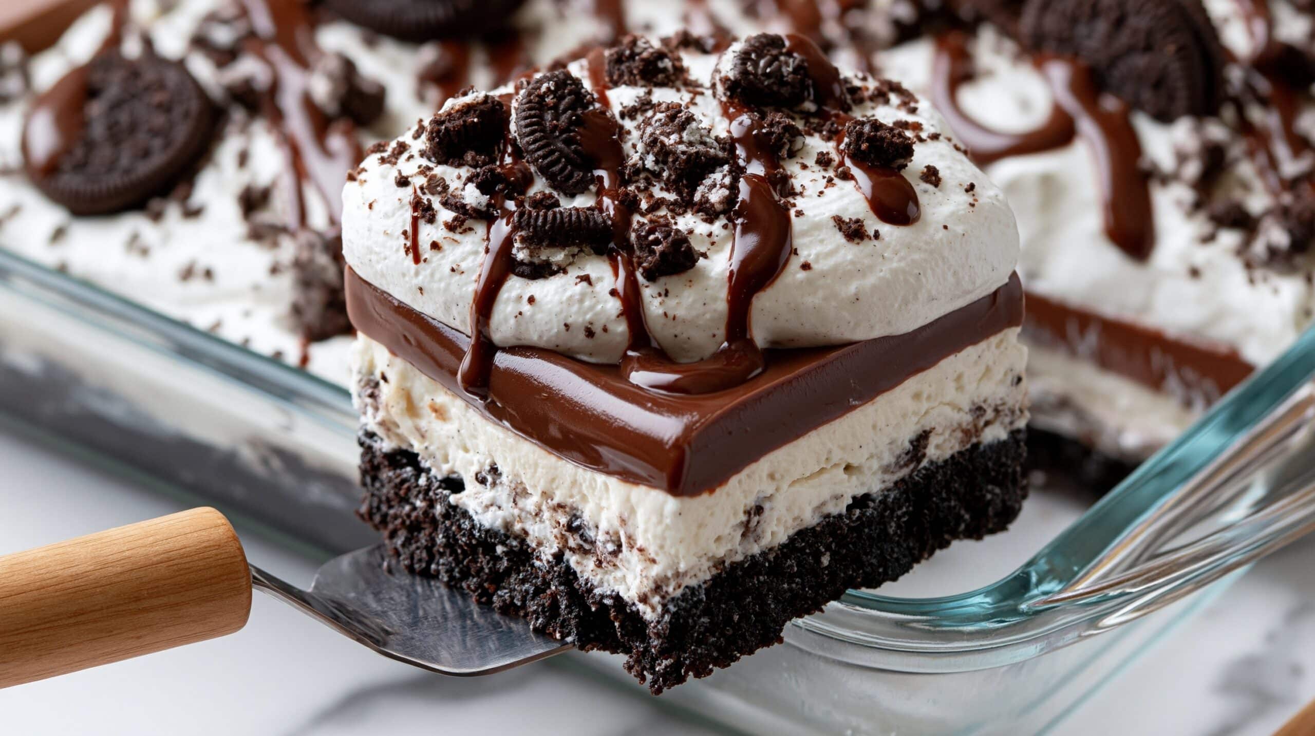 A square slice of Oreo dessert is being lifted from a clear glass dish with a spatula that has a wooden handle. The dessert has four layers: a dark crushed Oreo cookie crust at the bottom, a thick creamy white layer above it, a thick glossy milk chocolate layer on top of the cream, and a thick fluffy white whipped topping as the top layer. The whipped topping is decorated with crushed Oreo pieces and a drizzle of chocolate sauce. The dessert and spatula rest on a white marbled surface, with more of the dessert visible in the background, showing additional Oreo pieces and chocolate drizzle on the whipped layer. Photo taken with an iphone --ar 4:5 --v 7